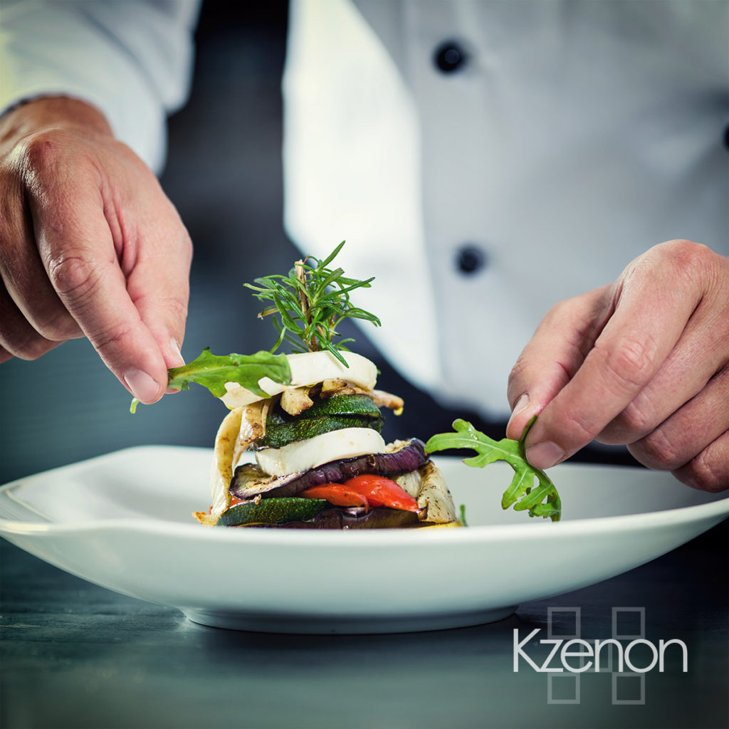 Chef in Restaurant garnishing vegetable dish