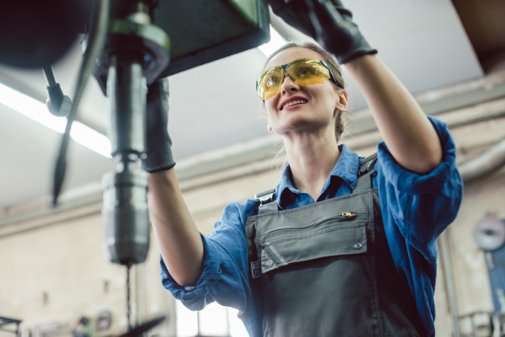 Woman working on drilling machine