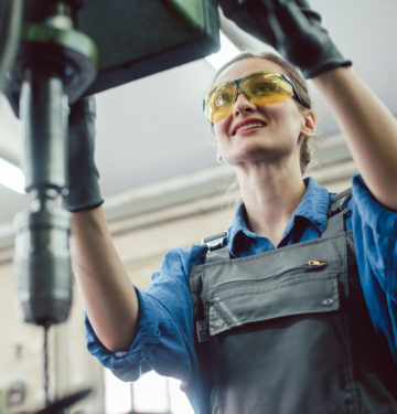 Woman working on drilling machine